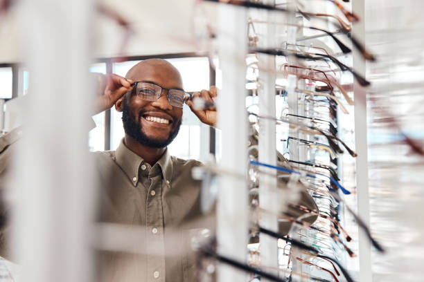 Shot of a young man buying a new pair of glasses at an optometrist store